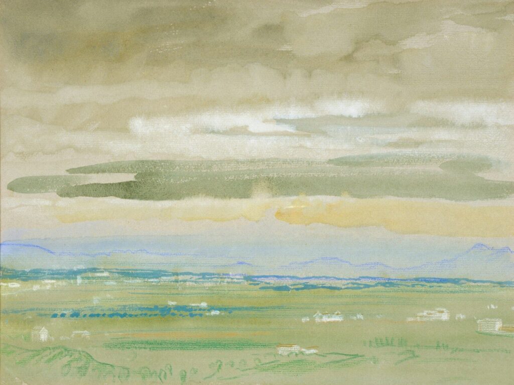 A hazy landscape with distant mountains and clouds